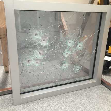 bullet holes through glass window