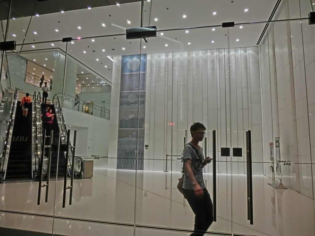 glass storefront with escalators