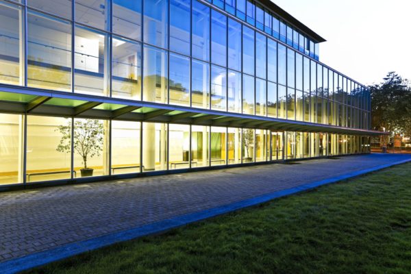 window walls of large building from outside at night