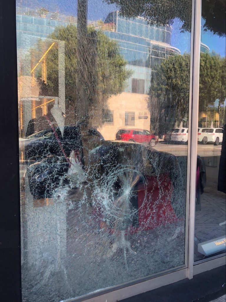 shattered glass surrounding bullet hole