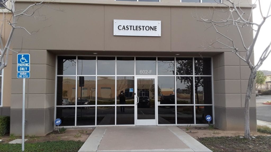 glass storefront under castlestone sign