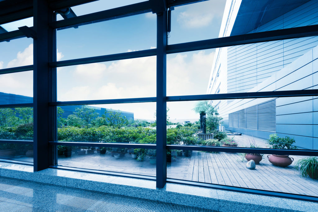 glass windows of building looking out into courtyard