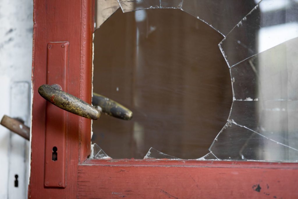 hole through glass on red door window