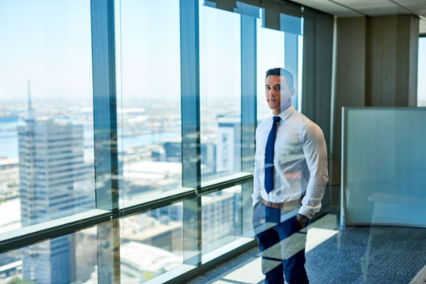 businessman in front of windows in office building