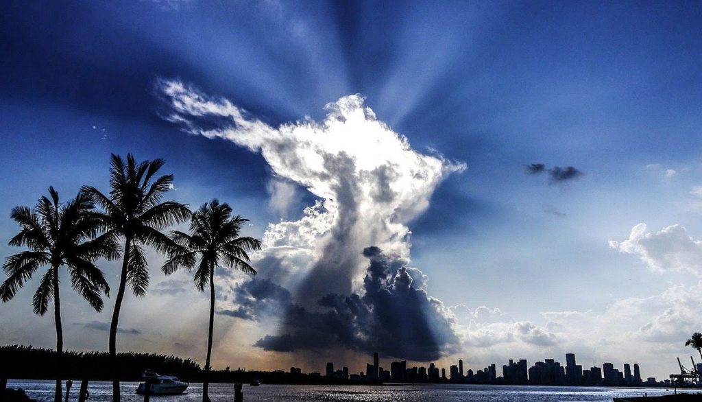 clouds over city scape and ocean