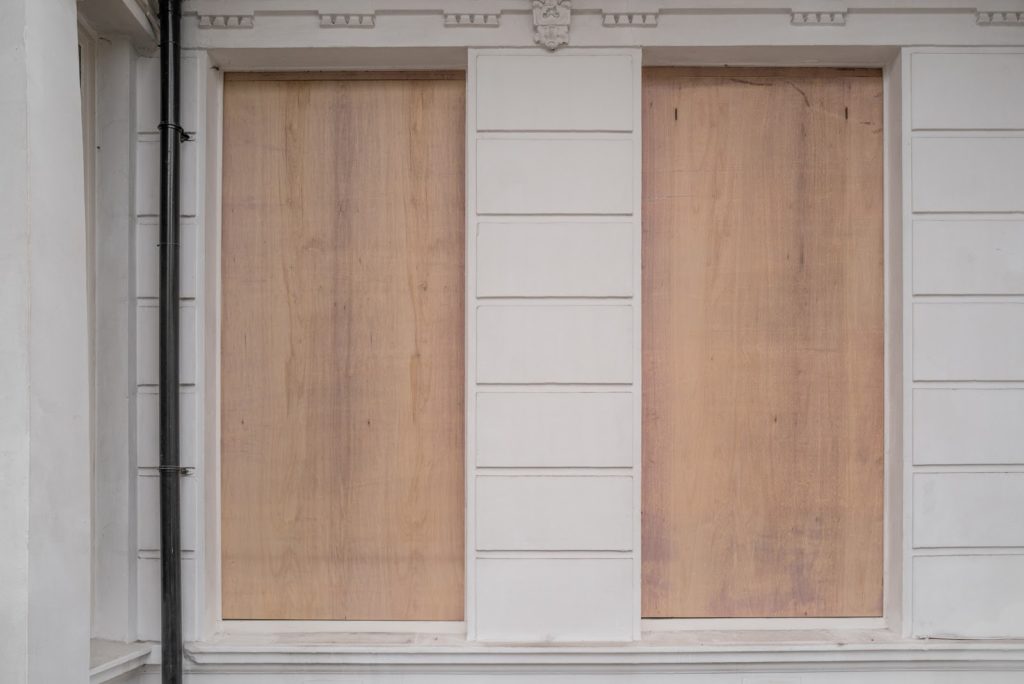 plywood boards in front of doors