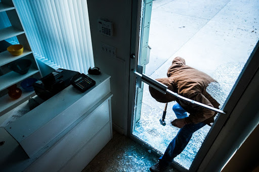 intruder broken through glass door into store