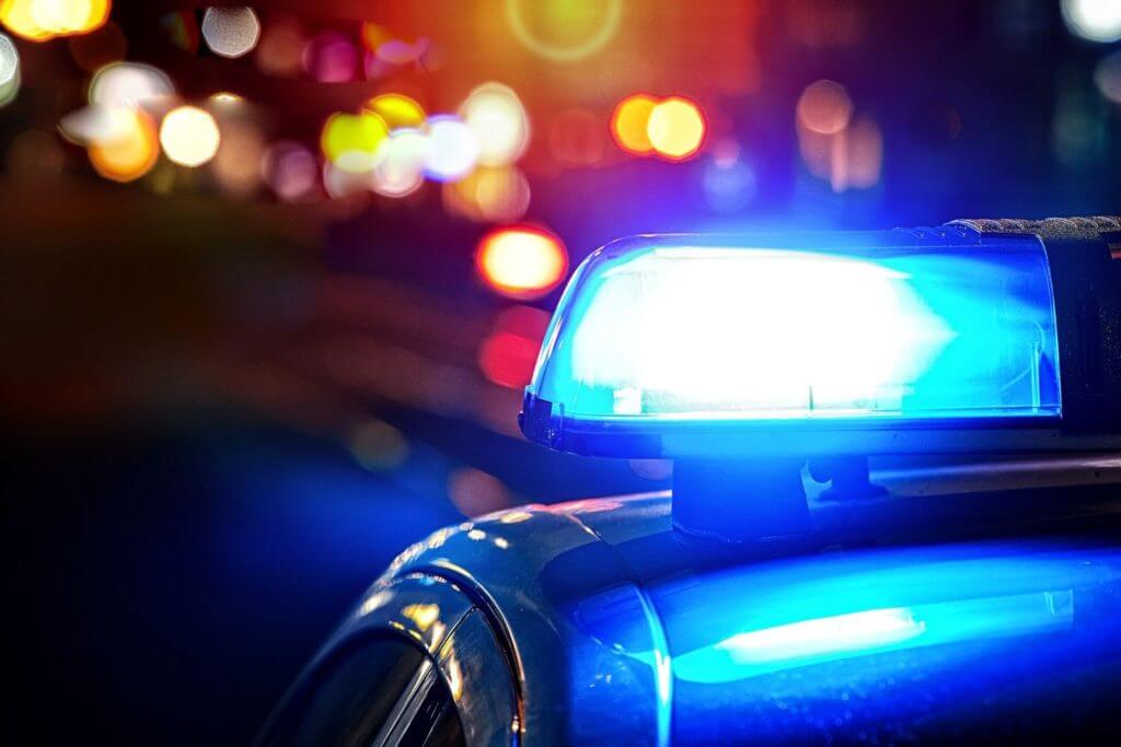 blue siren on top of car at night