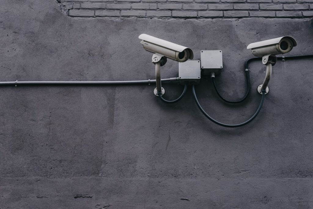 two security cameras on wall