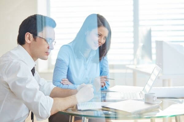 business man and woman discussing before laptop