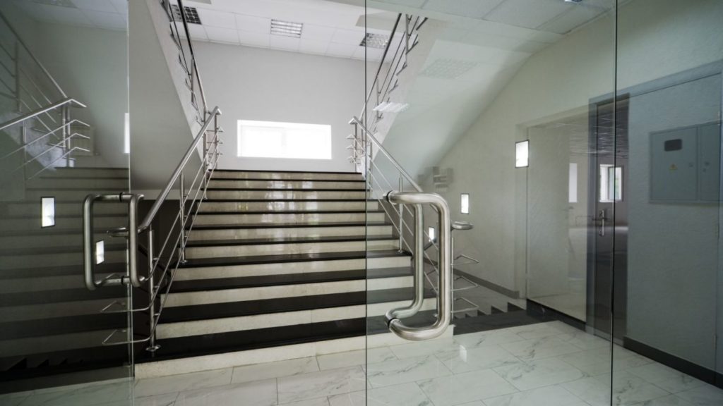 stairs in building with glass doors going in