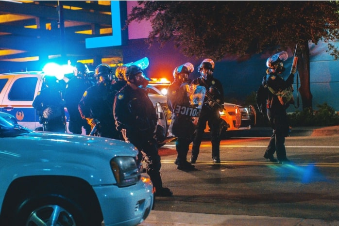 crew of police officers in the street at night