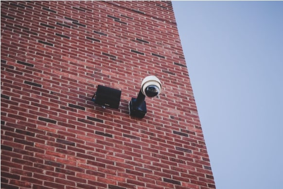 security camera on the edge of brick building