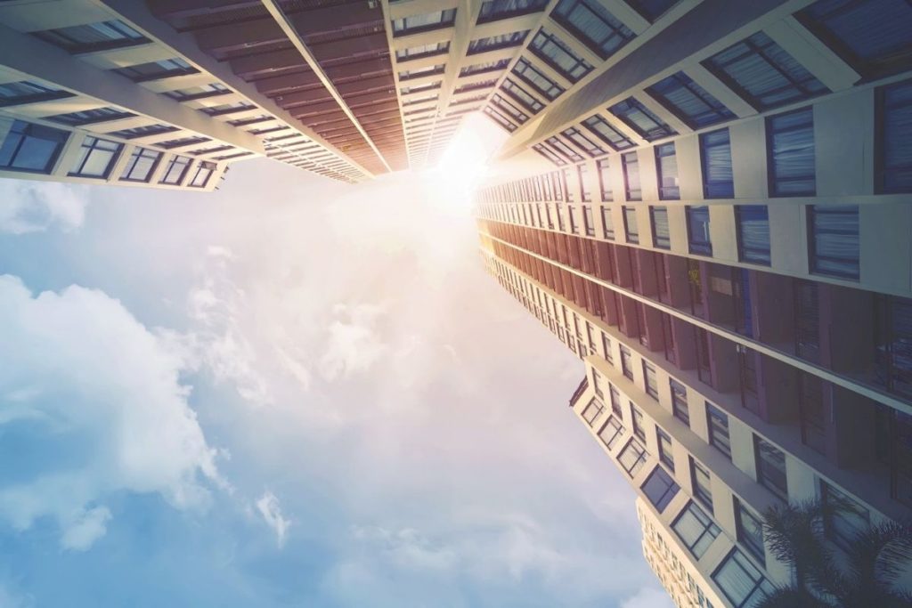 looking up at skyscrapers and the sun