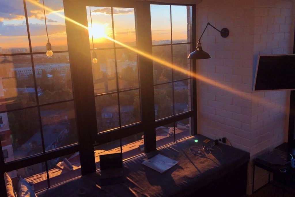 view of window panels inside an apartment looking outside at sunset